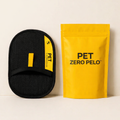 Black pet grooming tool and yellow 'PET ZERO PELO' package on a light background